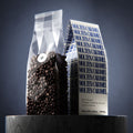 Molten Caramel dark roast — clear bag of beans beside the cream and blue box